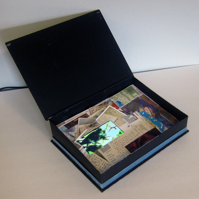 EVERY SECRET HAS ITS LITTLE CASKET (2003/2015), photo of small open decorated leather box with collage and video inside