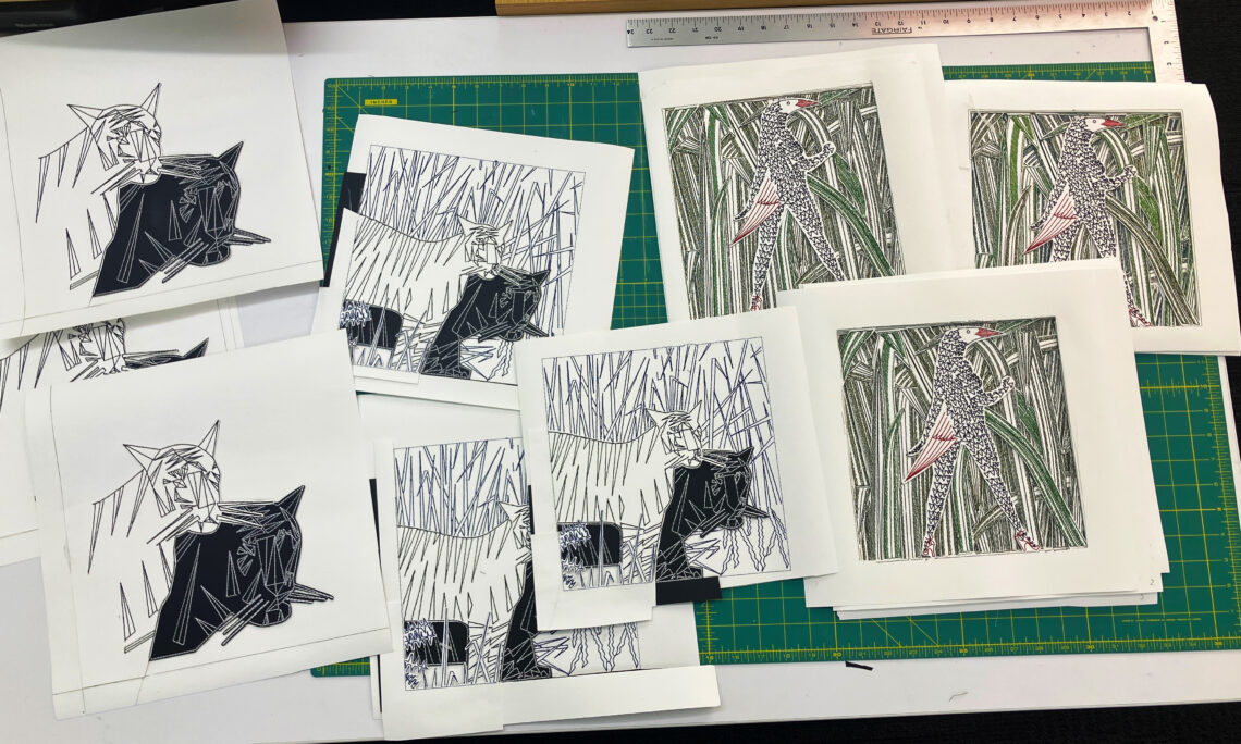 A work table filled with prototypes of stitched tactile graphics