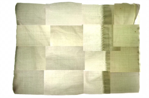 Photo of a patchwork/collage of white and off-white pillowcases - scene from the video, "Twiglight"